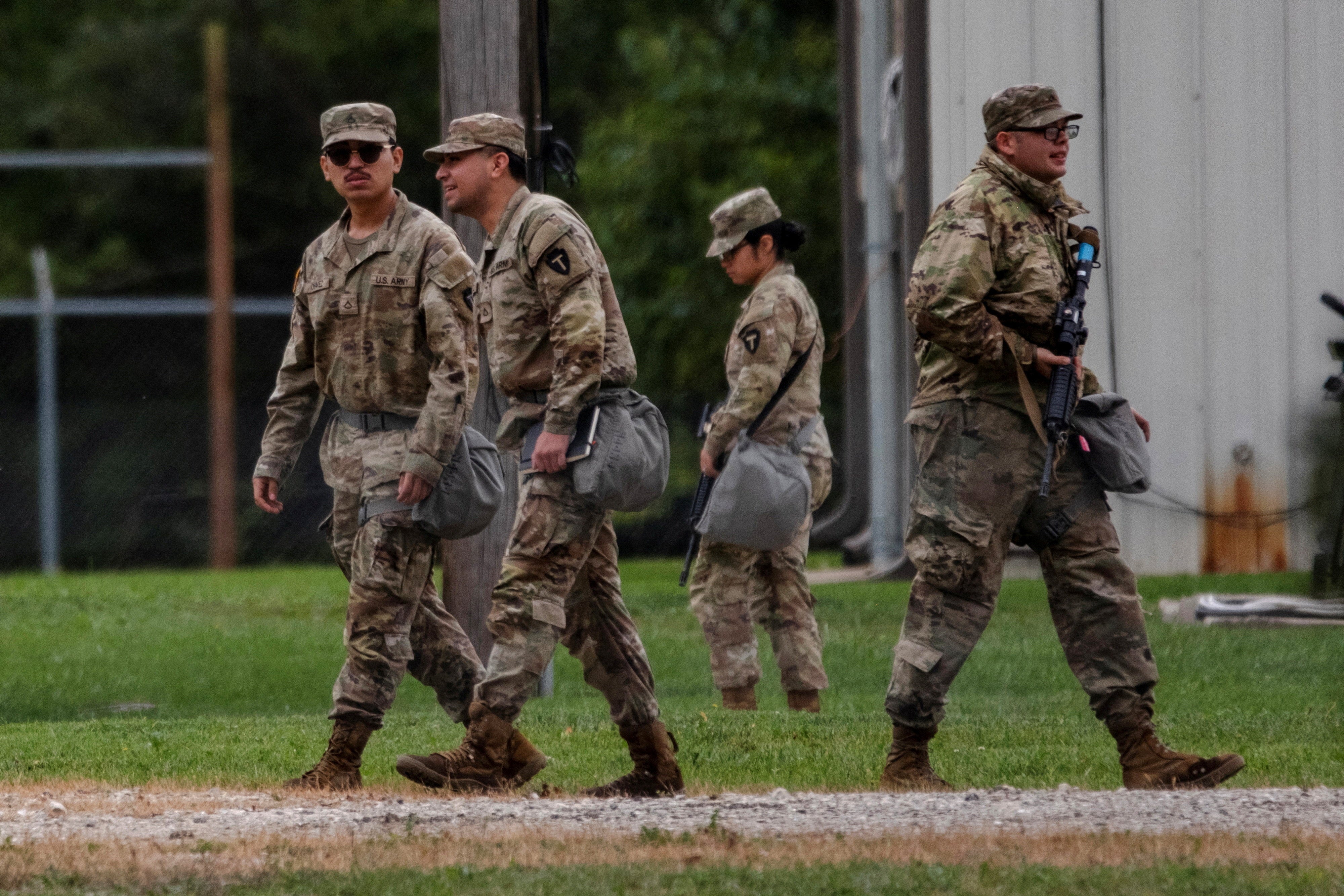 Texas National Guard troops walk through the Joliet Army Reserve Training Center, after U.S. President Donald Trump ordered increased federal law enforcement presence to assist in crime prevention, in Elwood, Illinois