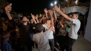 Palestinians celebrate on a street following the news that Israel and Hamas have agreed to the first phase of US president Donald Trump's plan for Gaza, in Khan Younis