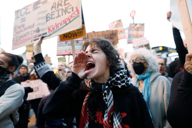 <p>People shout slogans while protesting the arrival of the Texas National Guard and US Immigration and Customs Enforcement agents in downtown Chicago, Illinois</p>