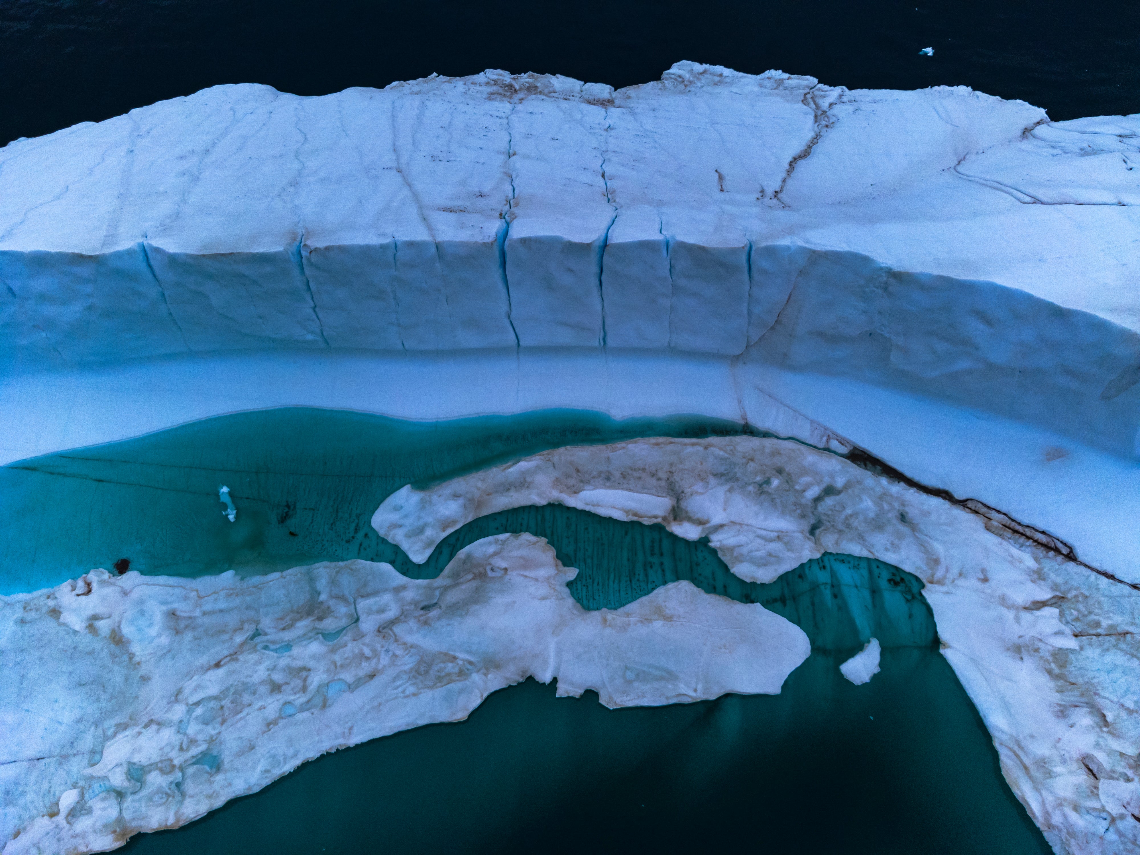 <p>A melting pond inside an iceberg from Greenland ice sheet in the Baffin Bay near Pituffik</p>