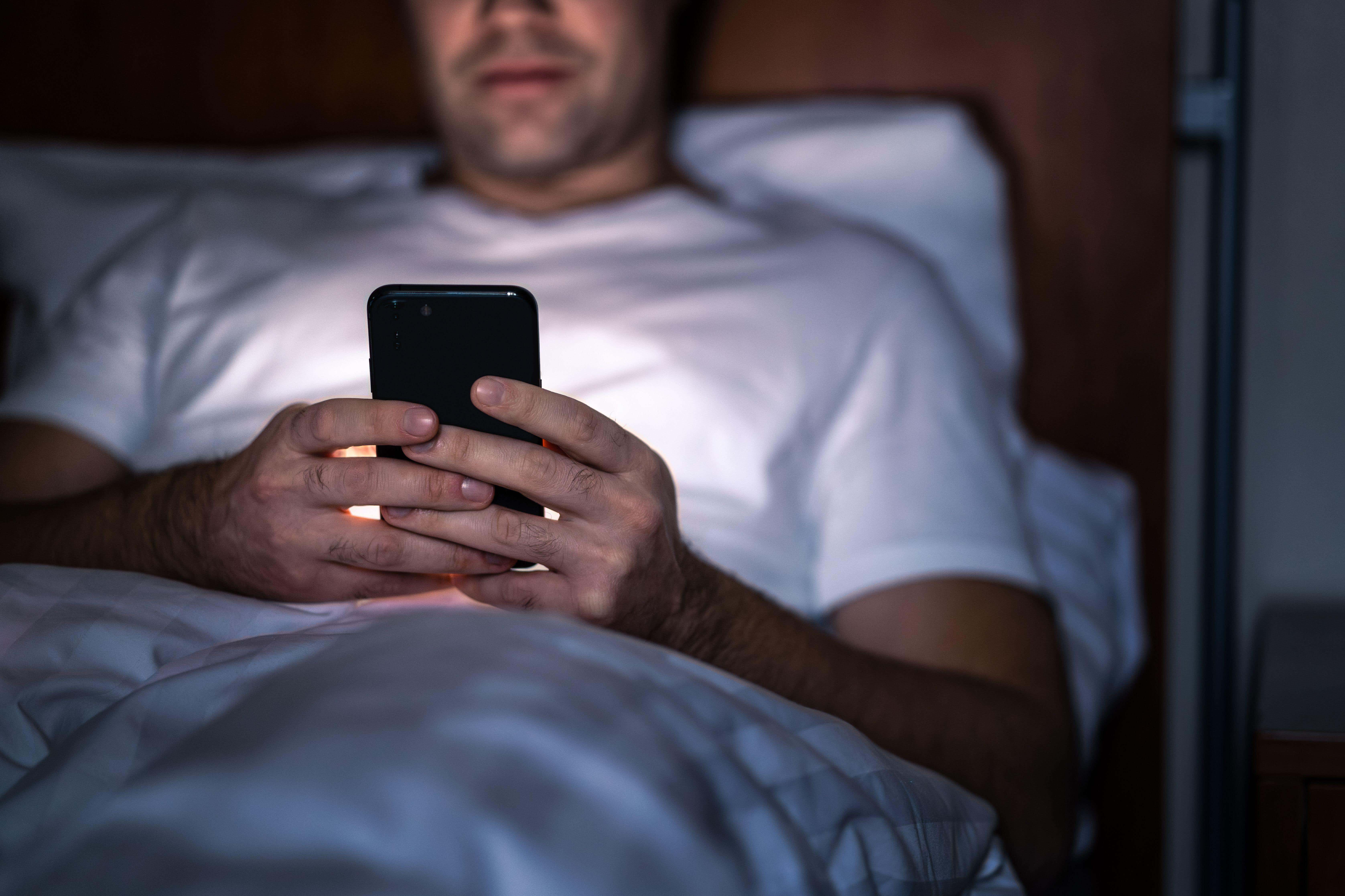 Posting online at night has been linked to worse mental wellbeing in a new study (Alamy/PA)