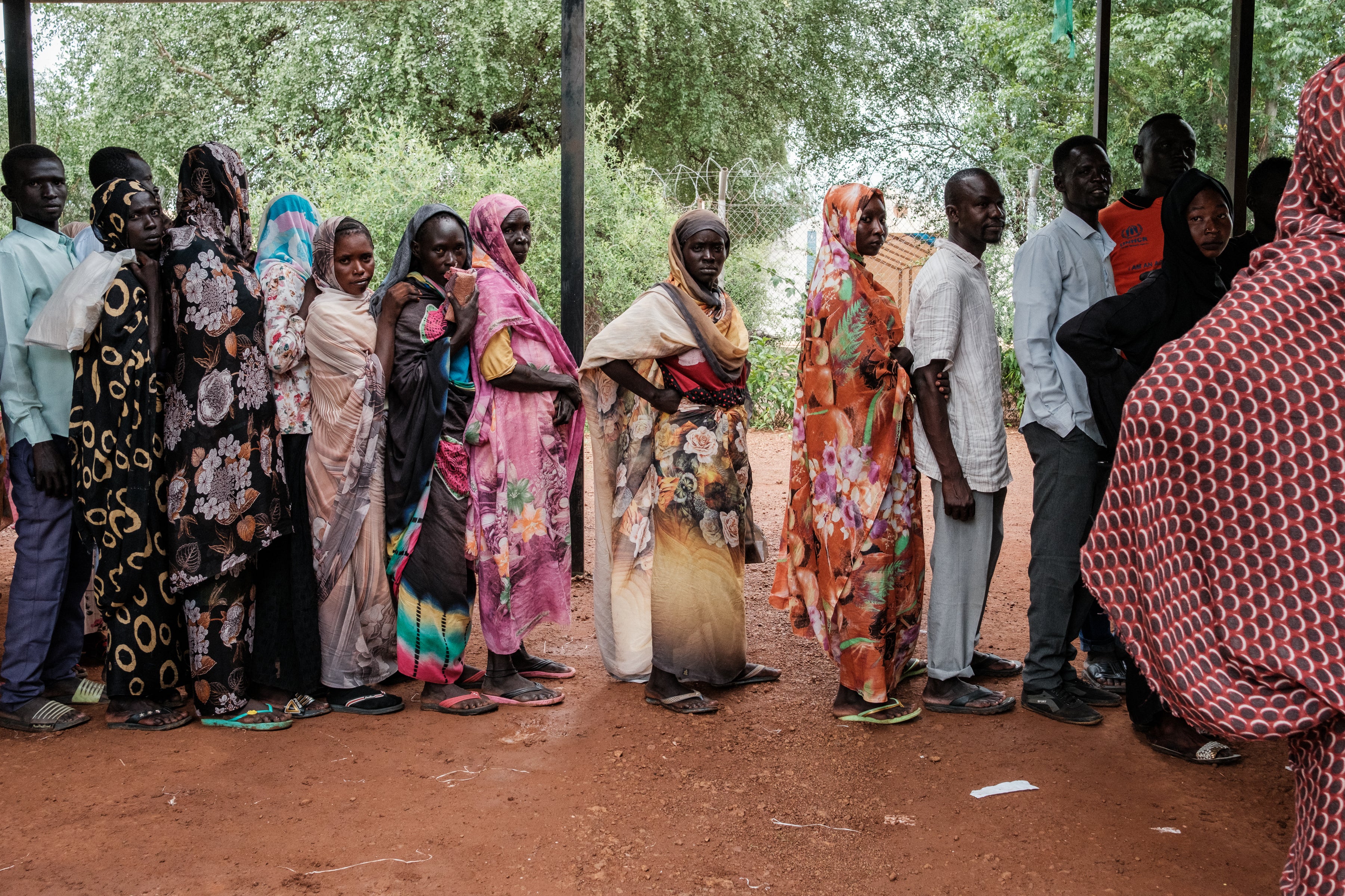 <p>People line up to receive aid at a refugee camp in Maban, South Sudan</p>