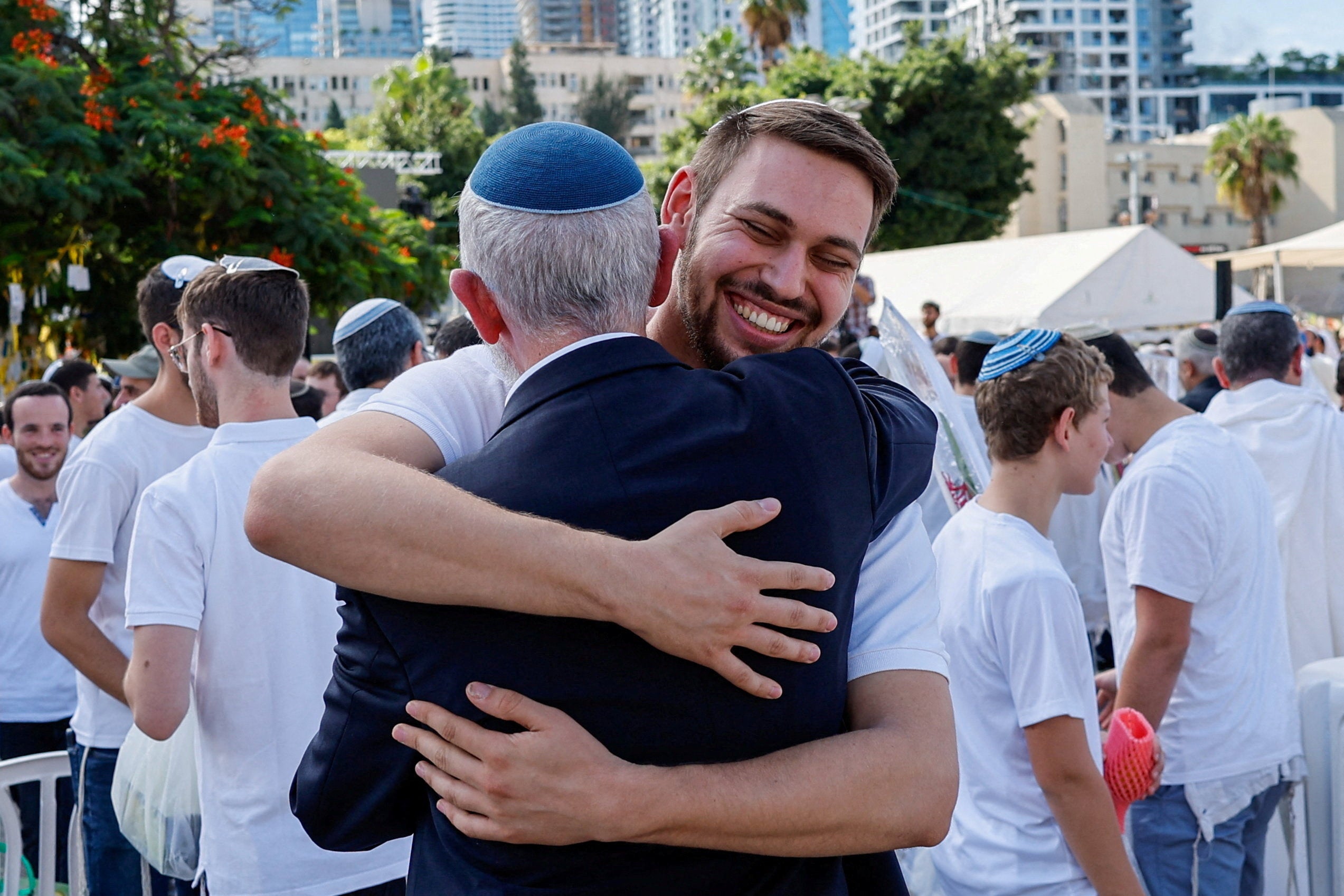 Jewish worshippers embrace one another after Israel’s government ratified a ceasefire with Hamas