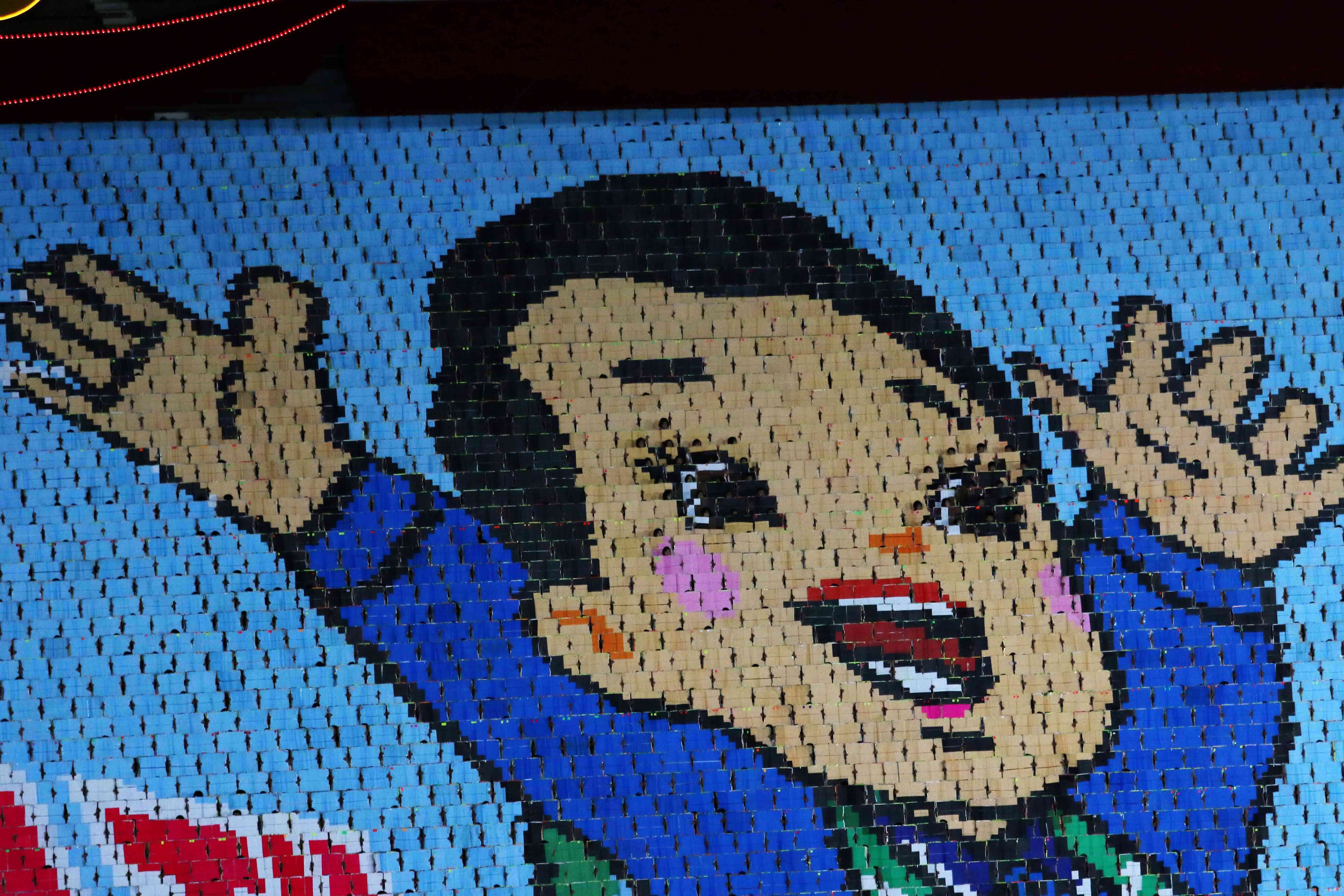 People turn cards to form an image of a child during the ceremony marking the 80th anniversary of the founding of the ruling Workers' Party at the May Day Stadium in Pyongyang, North Korea, Thursday, 9 Oct 2025