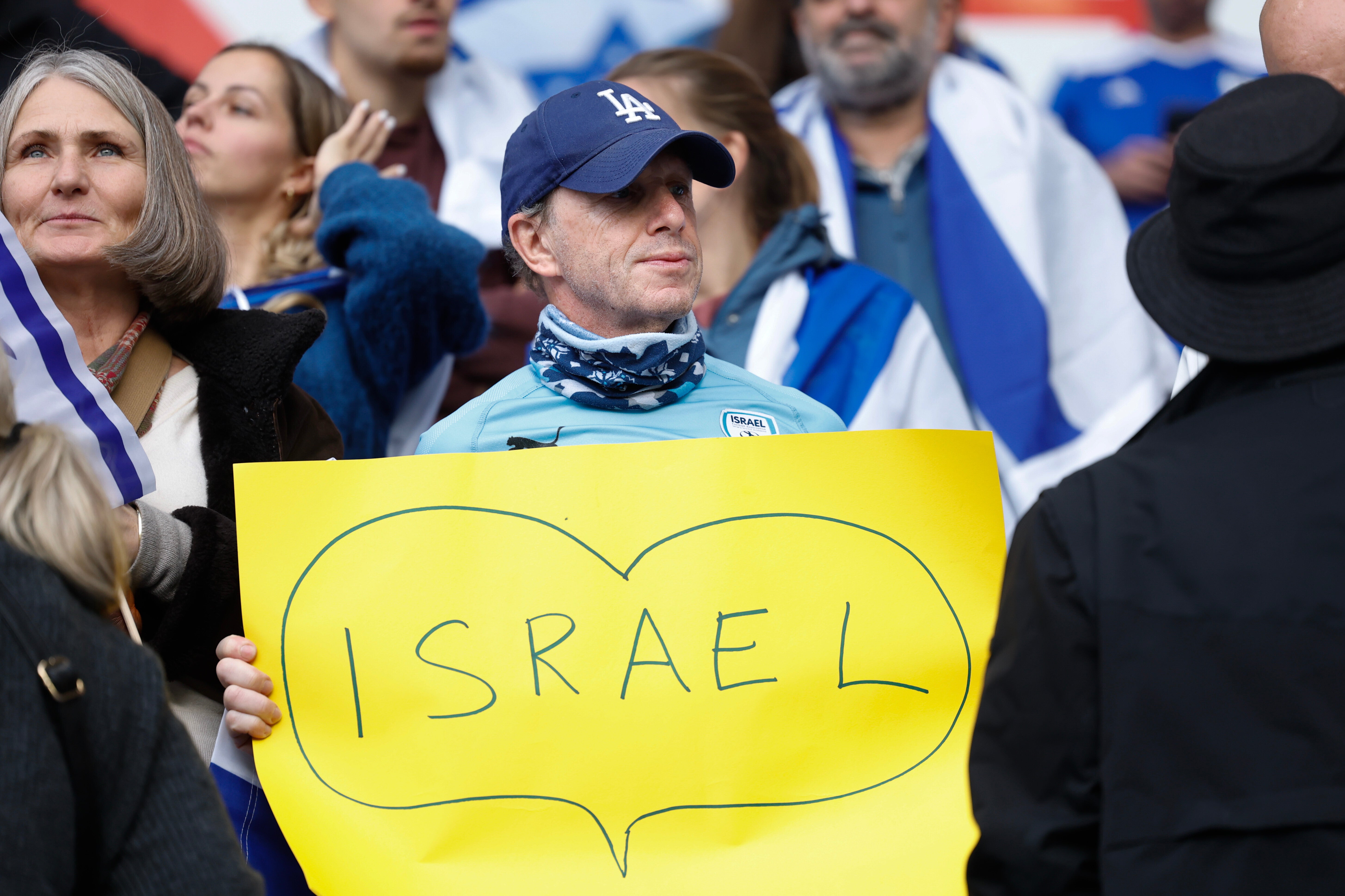 An Israeli supporter holds up a banner inside the stadium