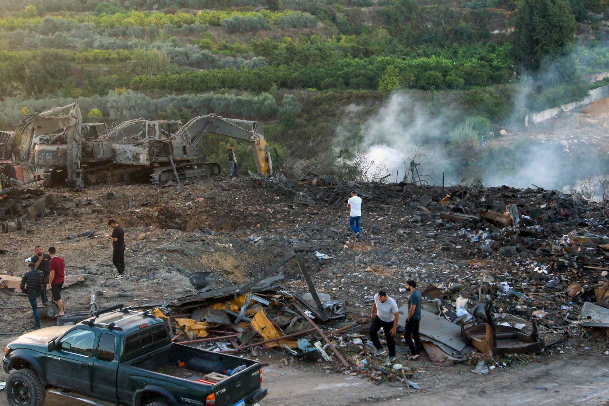 People inspect the damage following an overnight Israeli strike in Al-Msayleh area in southern Lebanon