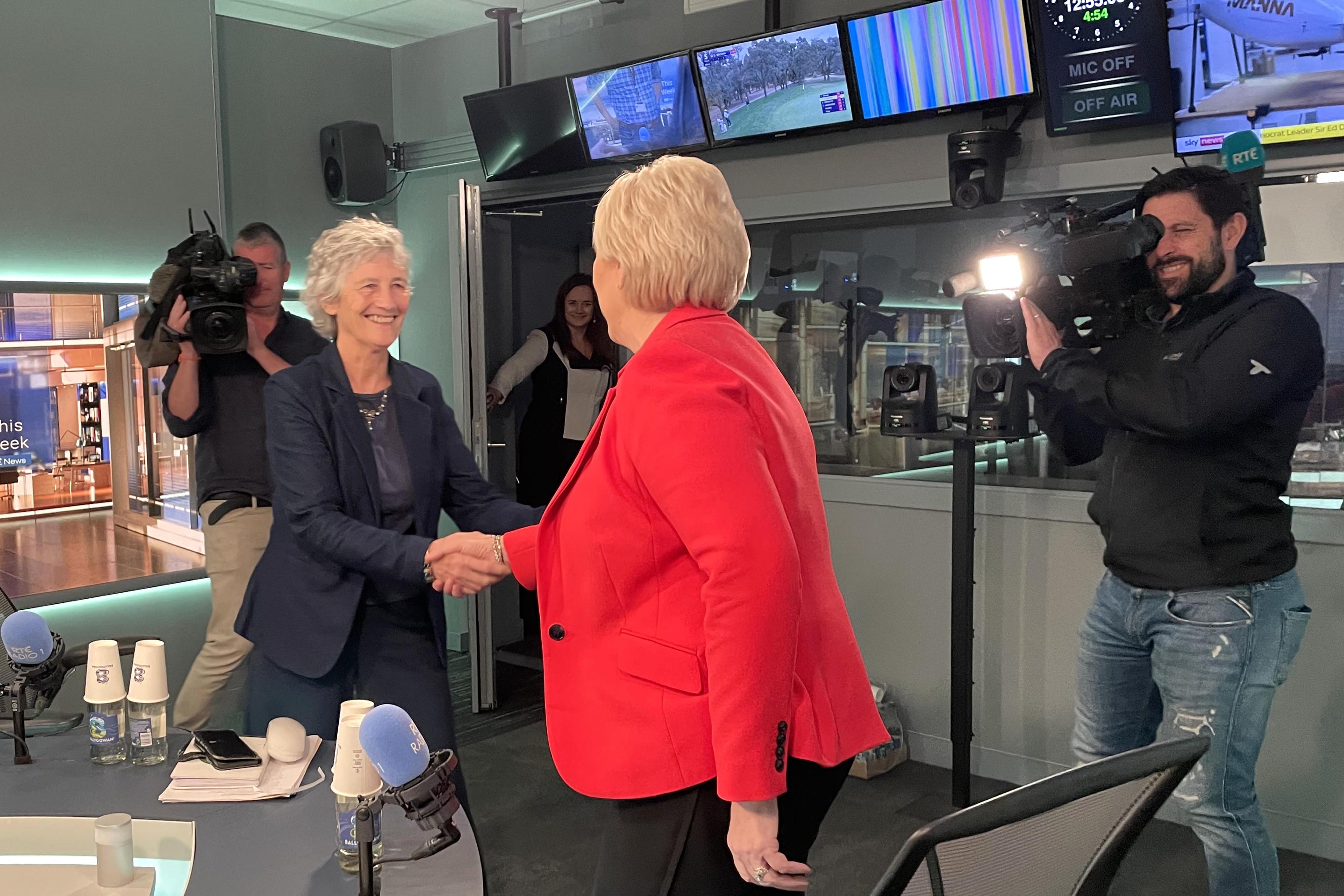 Irish presidential candidates Catherine Connolly, left, and Heather Humphreys greet each other ahead of a debate on RTE Radio One in Dublin (PA)