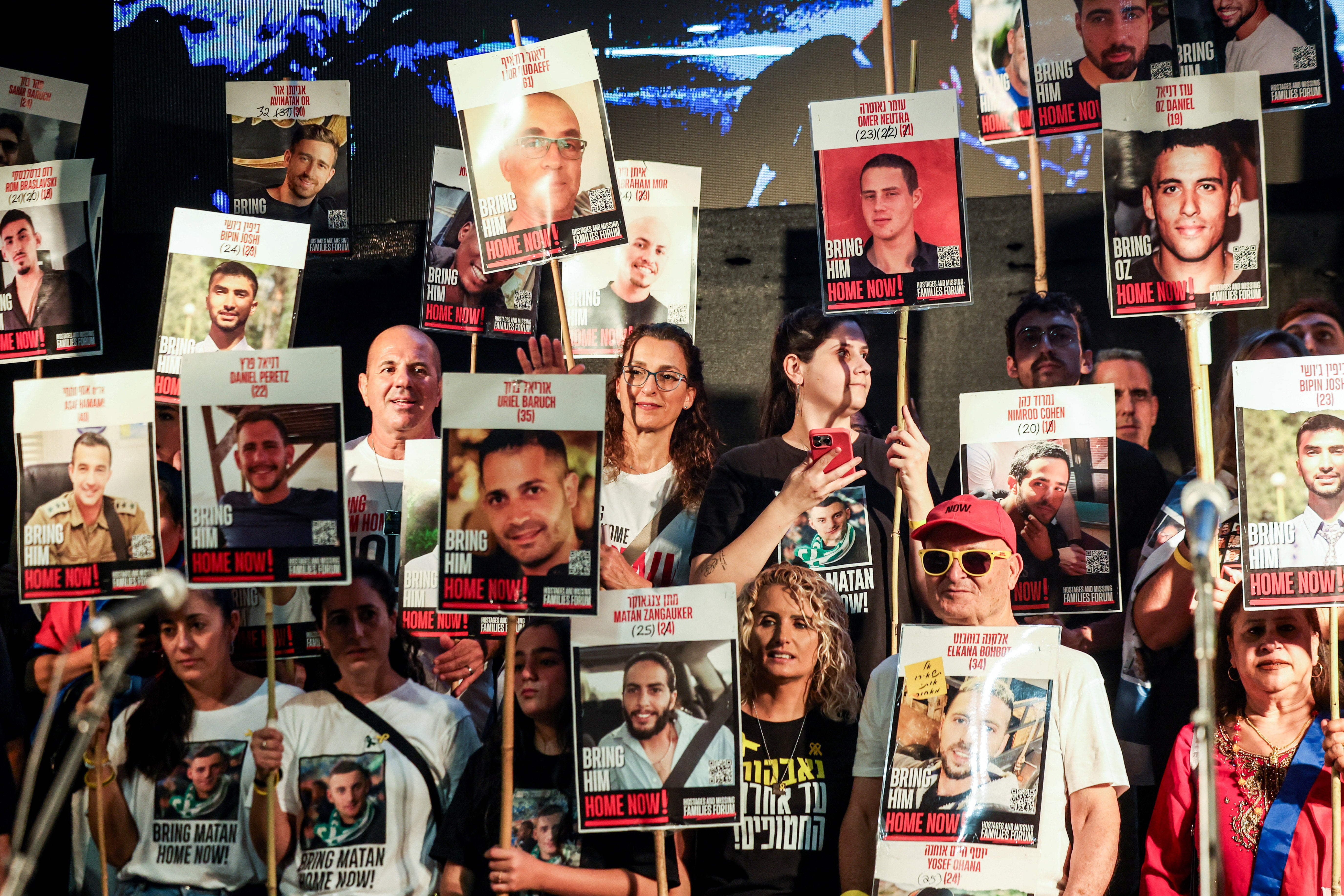 People hold placards with pictures of hostages who were kidnapped in the deadly October 7, 2023 attack by Hamas, at 