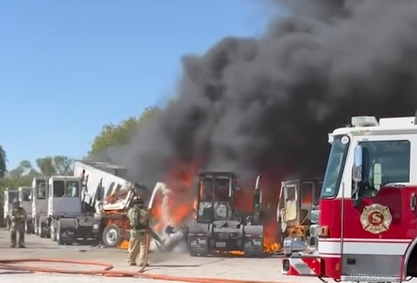 Firefighters work to battle the flames from a plane crash near Hicks Airfield in Tarrant County, Texas