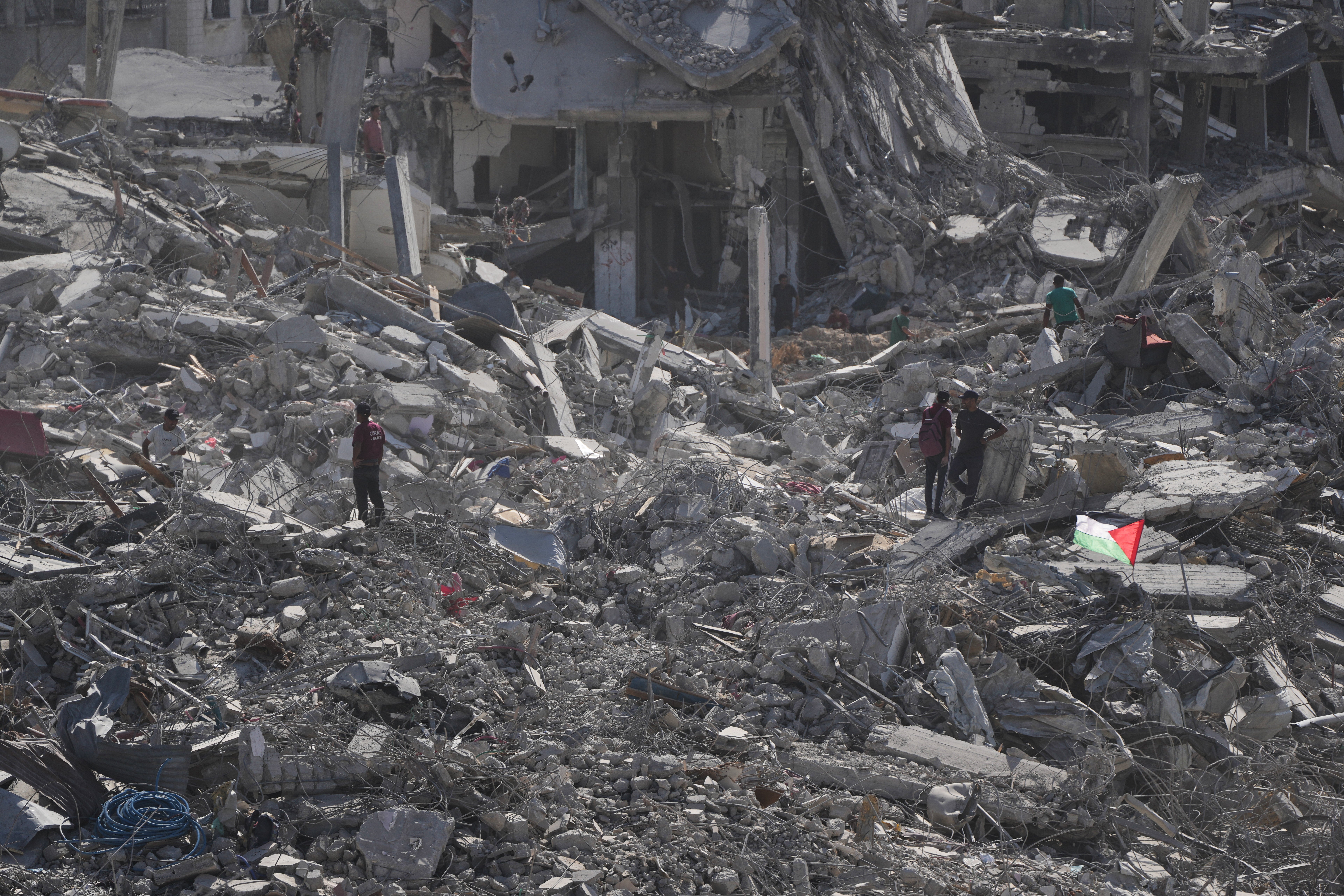 Displaced Palestinians inspect the remains of their destroyed homes in the heavily damaged Sheikh Radwan neighborhood in Gaza City