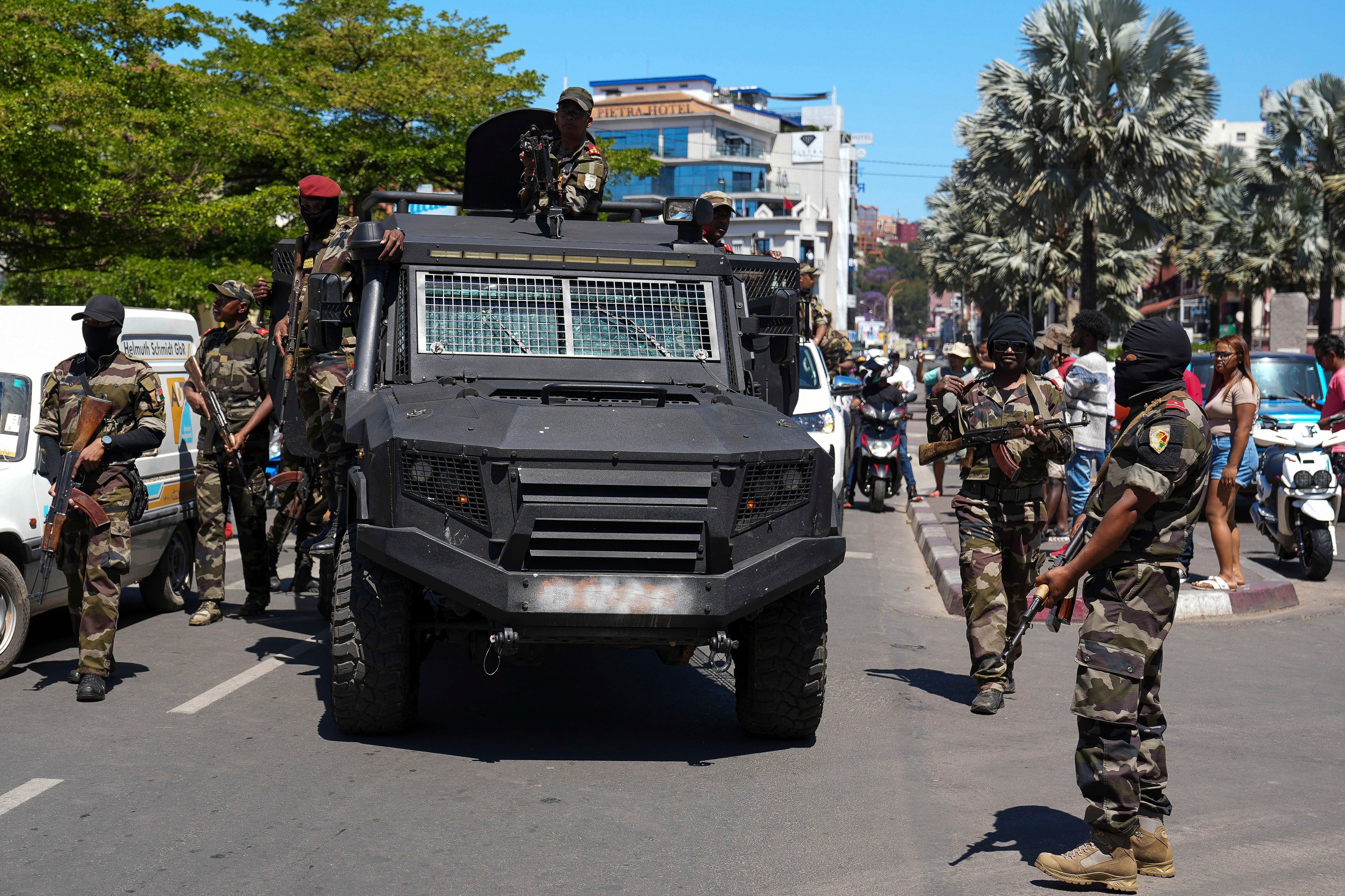 Soldiers are greeted by people gathering for a ceremony in tribute to demonstrators killed during recent anti-government protest in Antananarivo, Madagascar, Sunday, Oct. 12, 2025. (AP Photo/Mamyrael)