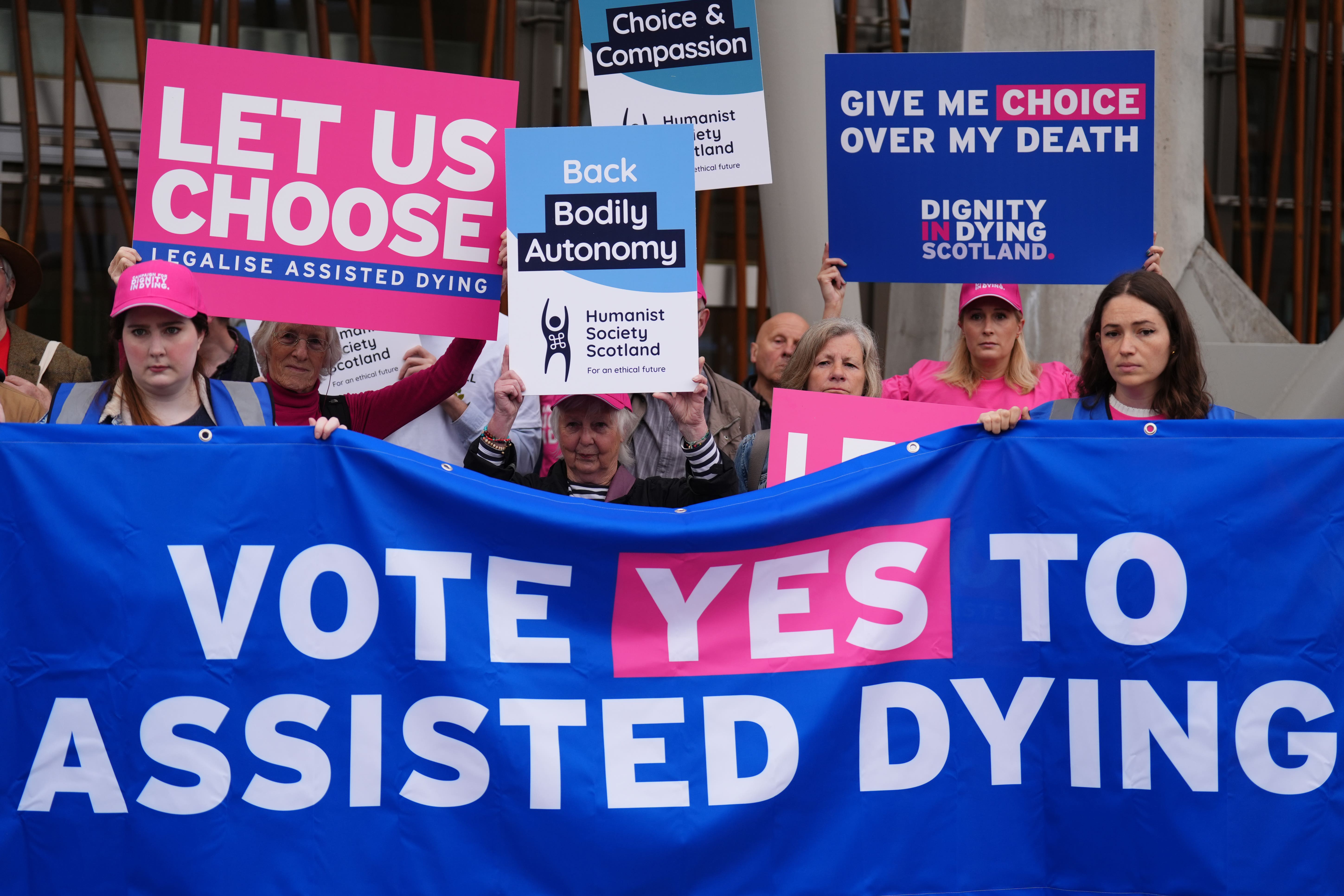 Members of Dignity in Dying Scotland and members of the Assisted Dying Coalition at a protest outside the Scottish Parliament (Andrew Milligan/PA)