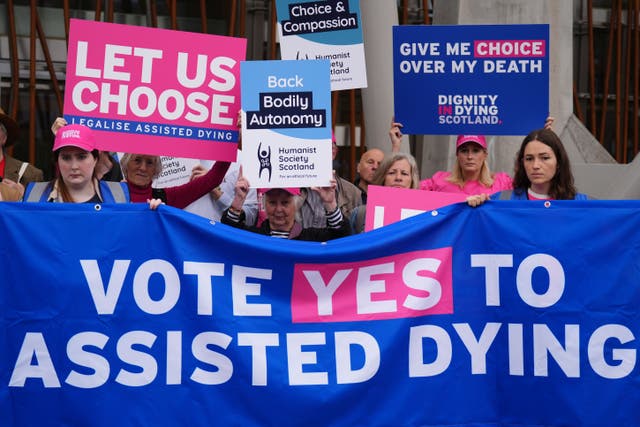 Members of Dignity in Dying Scotland and members of the Assisted Dying Coalition at a protest outside the Scottish Parliament (Andrew Milligan/PA)