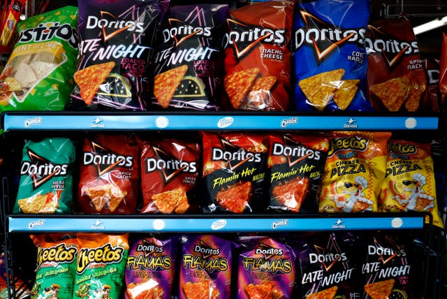 <p>Cheetos and Doritos maker PepsiCo says it plans to implement new recipes for the beloved chips that will not include artificial colors or flavors </p>