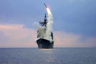 A Tomahawk Land Attack Missile (TLAM) is launched from the guided missile cruiser USS Cape St George