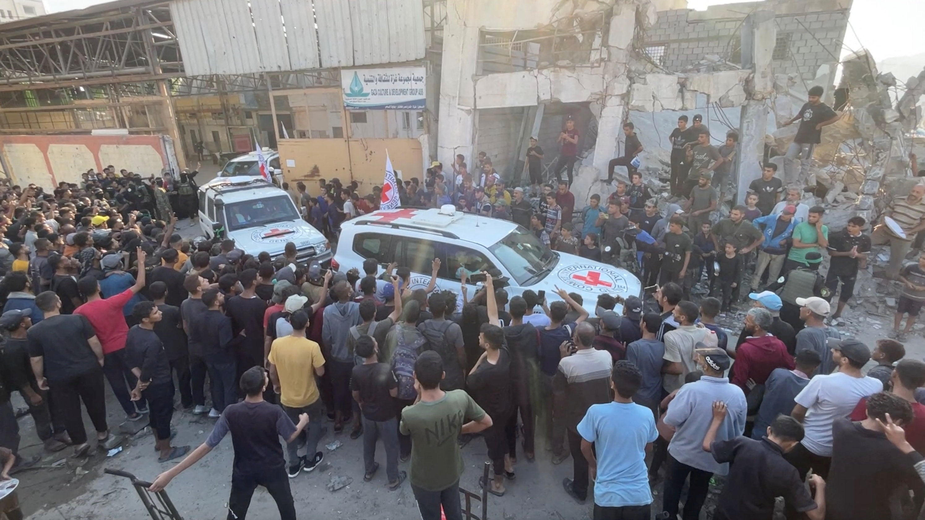 Red Cross vehicles transport hostages, held in Gaza since the deadly October 7, 2023 attack, following their handover as part of a ceasefire and hostages-prisoners swap deal between Hamas and Israel