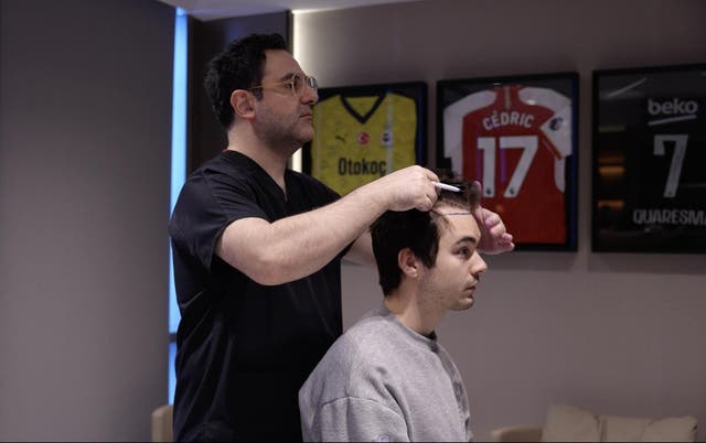 <p>Dr Levent Acar, founder and head surgeon of Cosmedica Clinic, during a hair transplant consultation.</p>