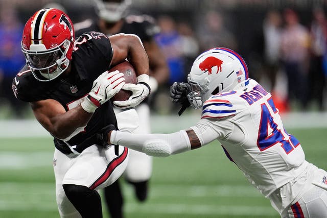 Atlanta Falcons running back Bijan Robinson runs past Buffalo Bills cornerback Christian Benford (Mike Stewart/AP)