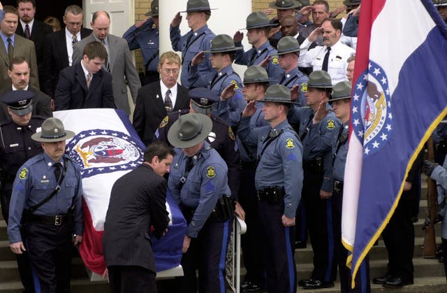 <p>Members of the Missouri State Highway Patrol salute the body of fellow officer Sgt. Carl '’Dewayne'’ Graham Jr., after funeral services March 24, 2005, in Dexter, Mo. (AP Photo/Bill Boyce, File)</p>