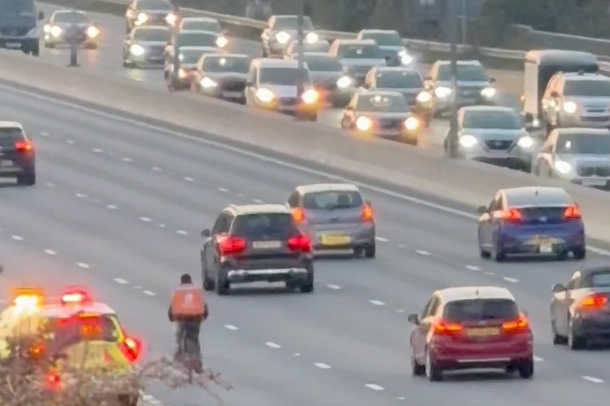 Just Eat delivery cyclist pedals along M4 in rush hour traffic before he is stopped by traffic officers