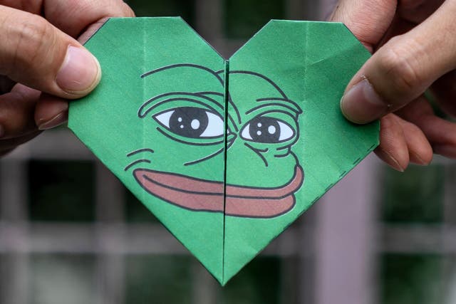 <p>An origami of Pepe the Frog – an online meme that gained popularity through 4chan – is held up during protests in Hong Kong on 24 September, 2019</p>