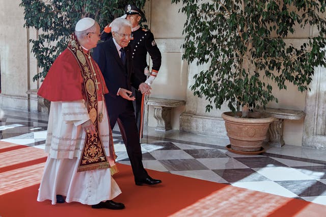 <p>Italian President Sergio Mattarella, right, welcomes Pope Leo XIV as he arrives at the Quirinale Presidential Palace in Rome</p>