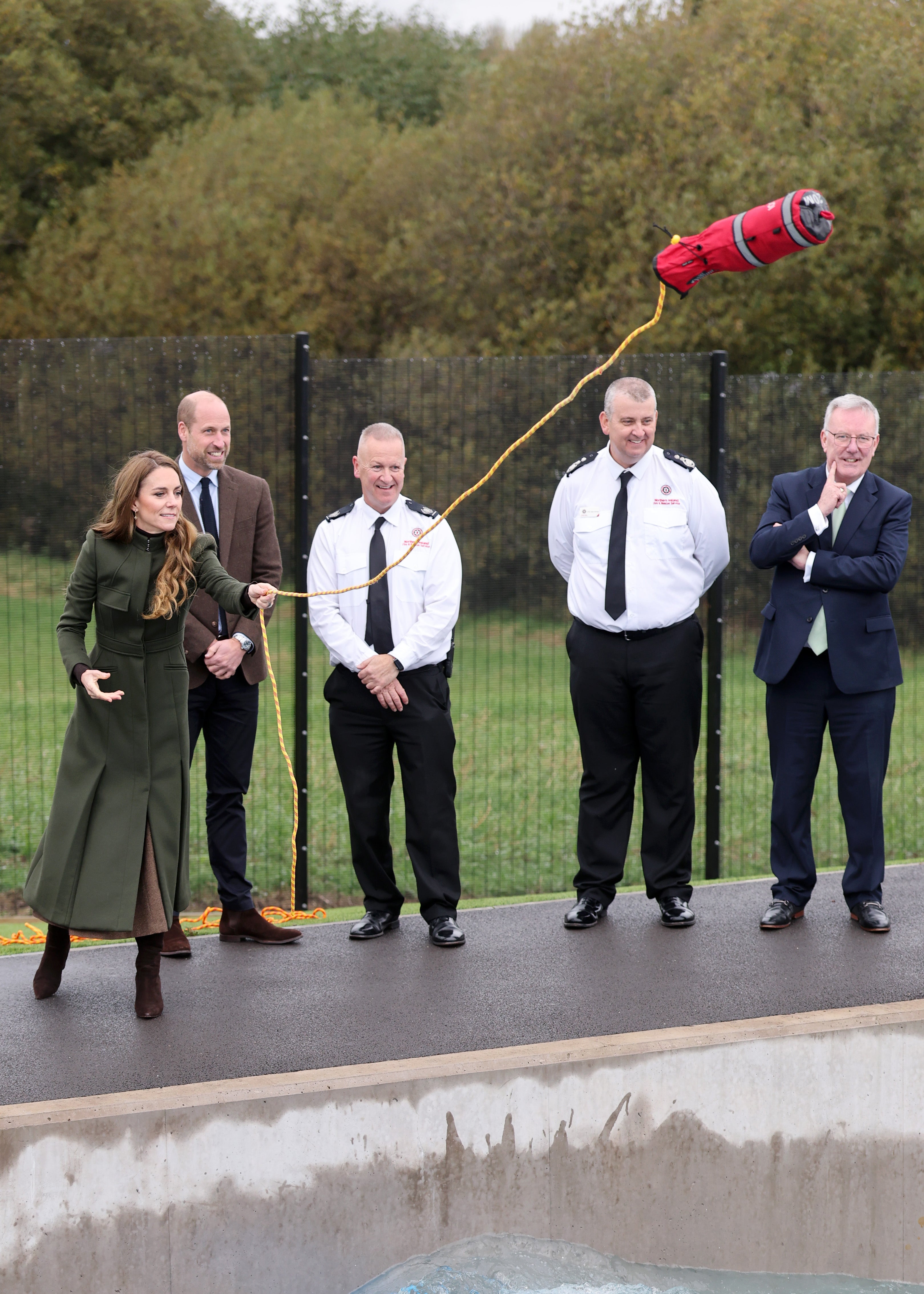 They tried their hand at saving mock casualties who had fallen into the raging torrents of a flood simulator - but failed to throw the line quickly enough