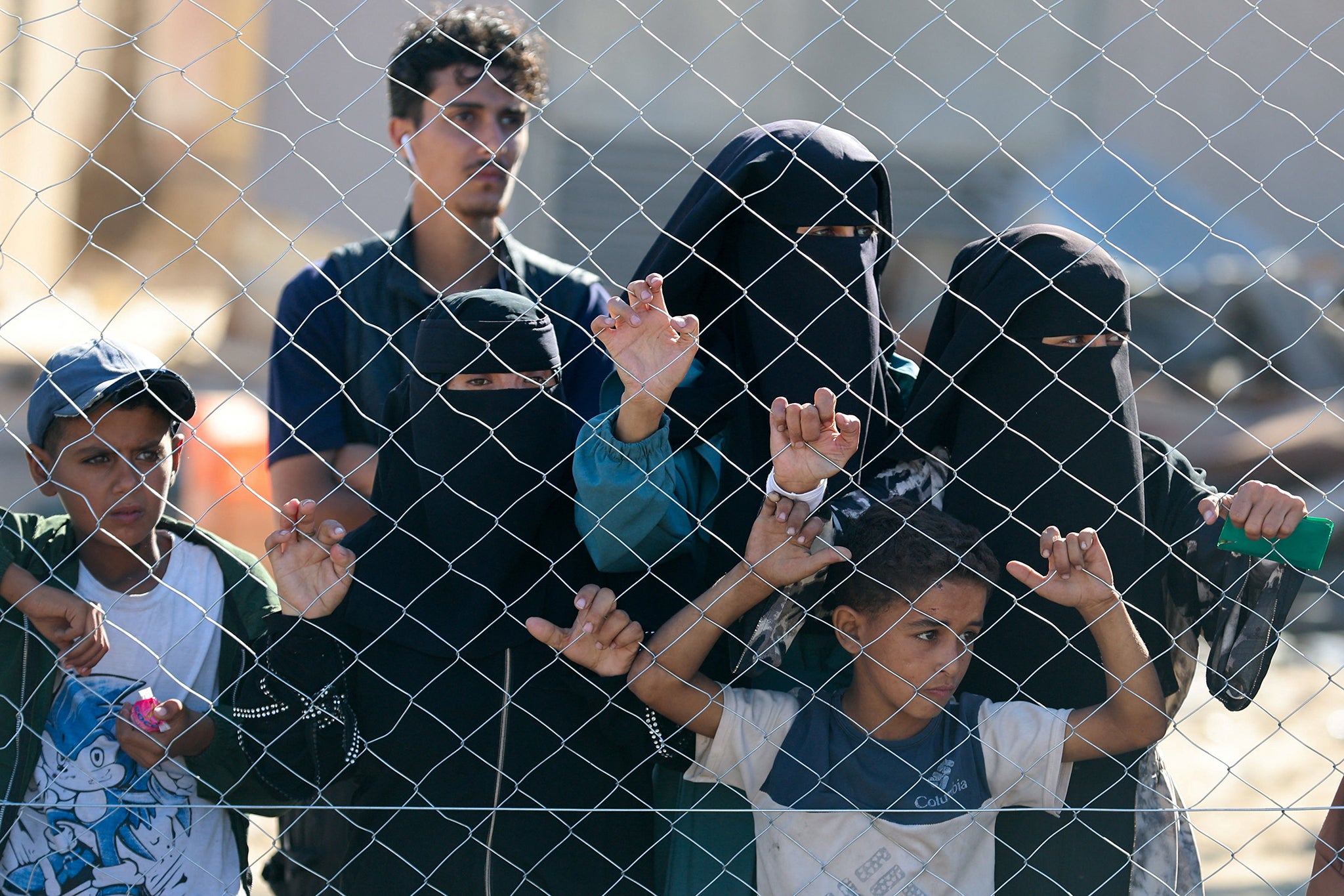 People watch as a truck carrying the bodies of Palestinians arrives at Nasser hospital on Tuesday