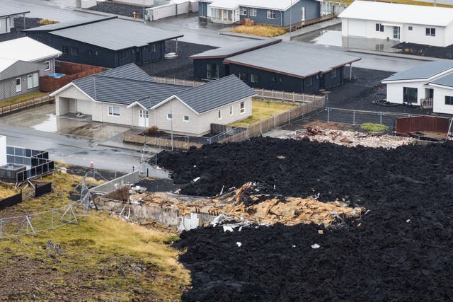 <p>A house, destroyed by lava, is visible on the edge of a hardened flow Friday, Oct. 10, 2025, that reached Grindavik, Iceland, from a Jan. 14 2024, eruption. (AP Photo/Marco di Marco)</p>