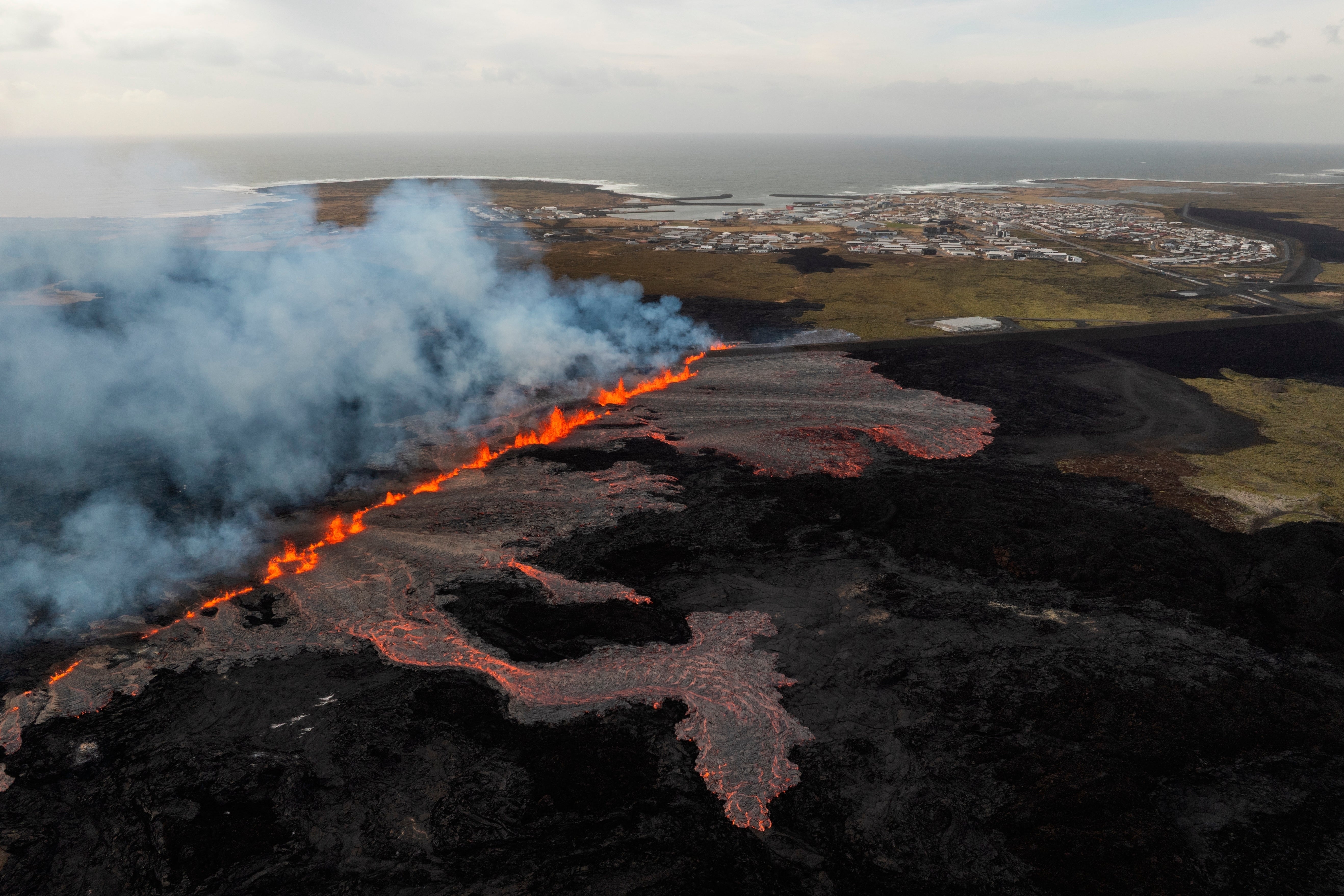 A volcanic eruption is visible near the town of Grindavik, on the Reykjanes Peninsula, Iceland, April 1, 2025. (AP Photo/Marco di Marco, File)