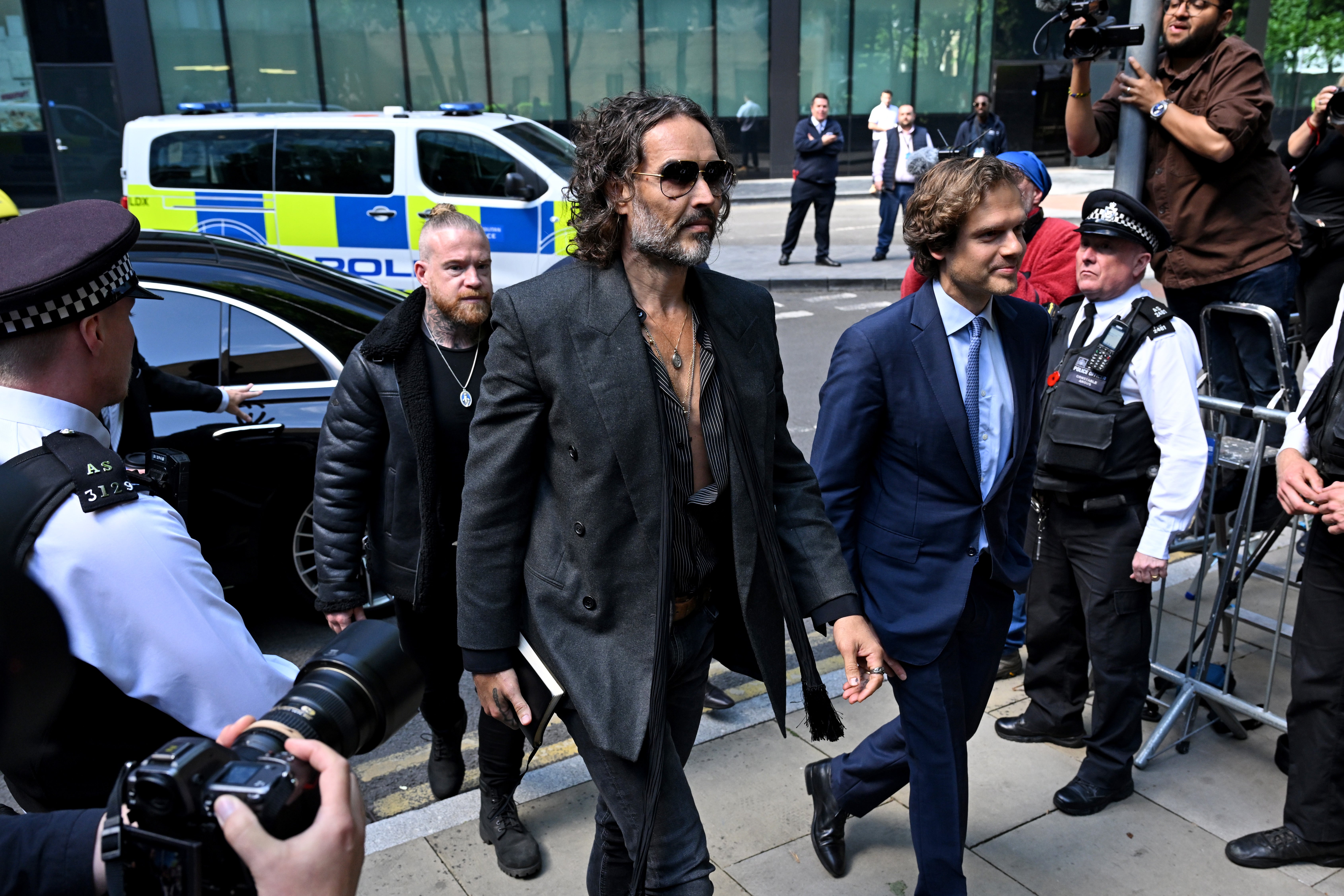 Comedian and conspiracy theorist Russell Brand, who is facing charges of rape and sexual assault in the U.K., has appeared more than once on the calls. Brand pleaded not guilty and denies any wrongdoing