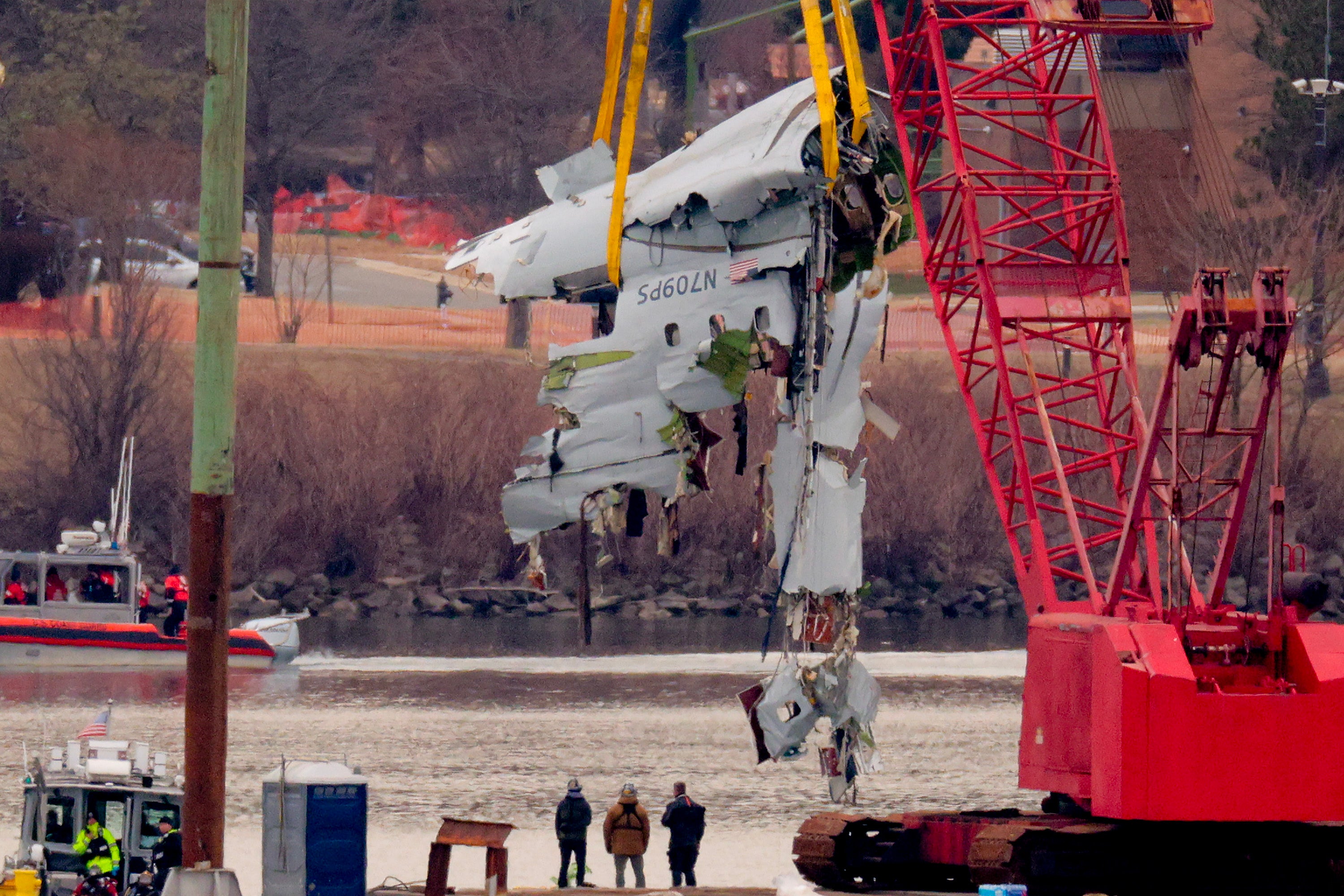 Part of an American Airlines jet is lifted from the Potomac River after it collided with a U.S. Army Black Hawk helicopter in Washington, D.C.