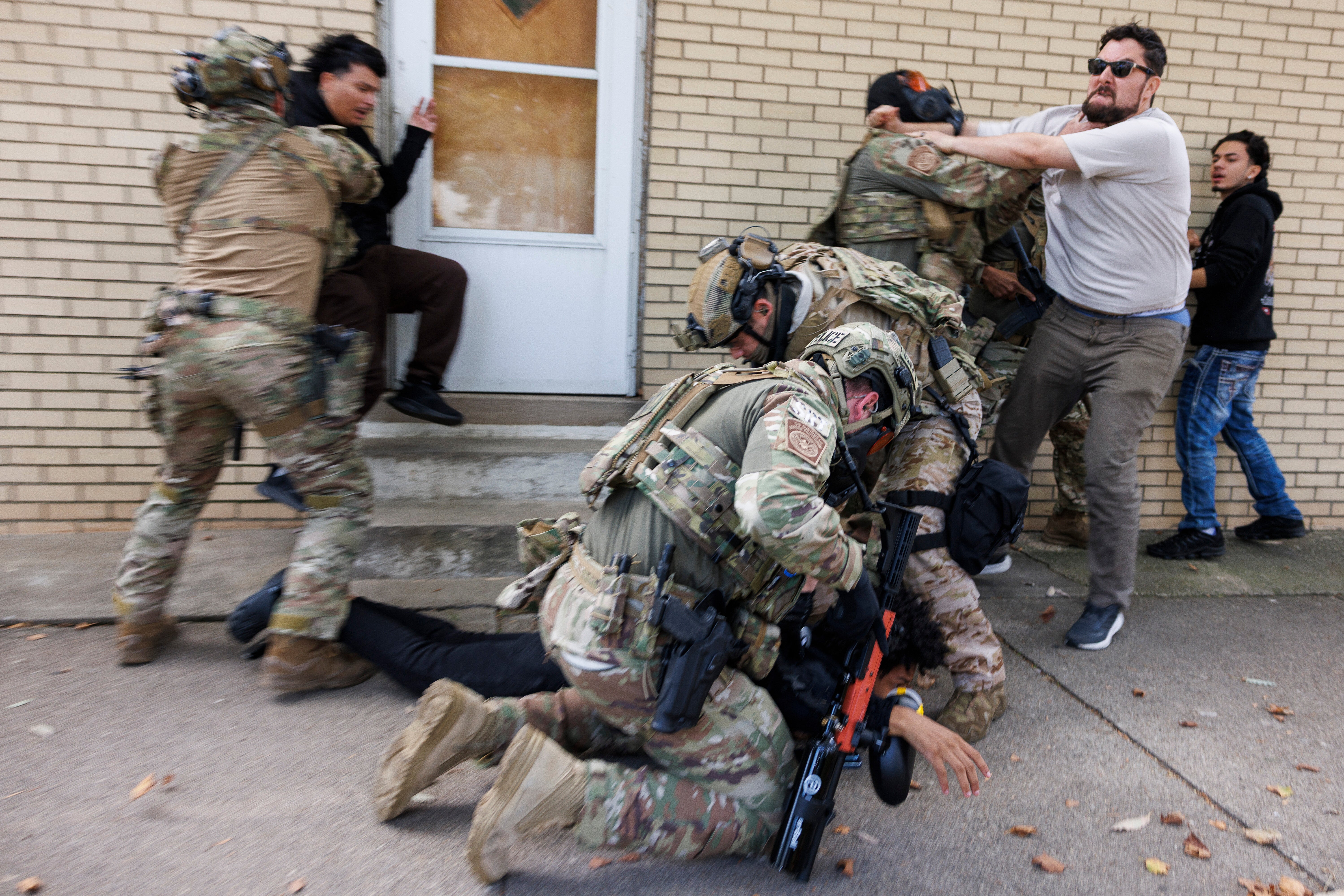 ICE agents detain a protester as other protesters try to stop them in East Side, Chicago, Tuesday, Oct. 14, 2025. (Anthony Vazquez/Chicago Sun-Times via AP)