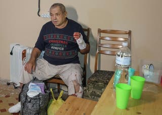 A wounded hospital patient takes shelter inside a basement during a Russian air strike in Kharkiv