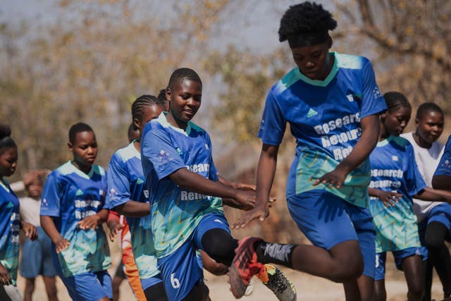 <p>Girls warm up for a soccer match as part of activities against early child marriages and teen pregnancies at a school in Shamva, Zimbabwe, Friday, Aug. 29, 2025. (AP Photo/Aaron Ufumeli)</p>