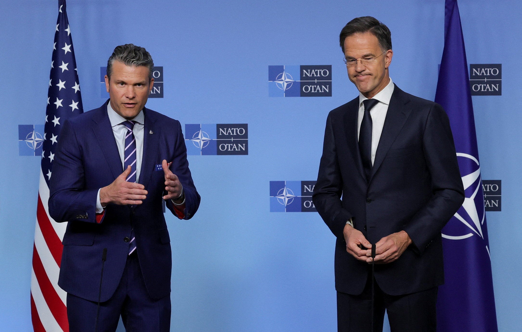 Pete Hegseth (L) and Nato chief Mark Rutte speak at a conference in Brussels ahead of Zelensky’s visit to Washington
