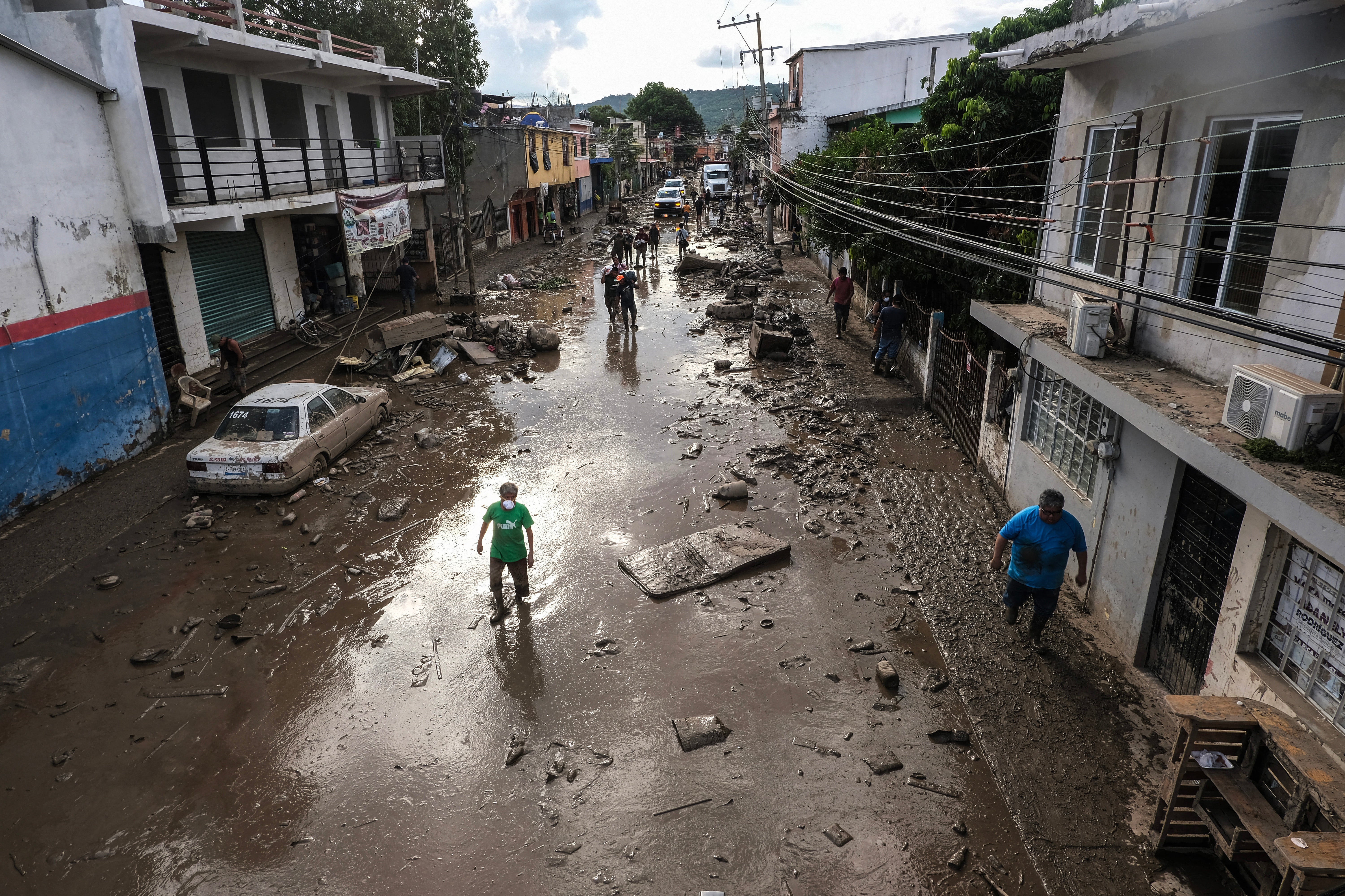 <p>Street covered in mud and debris caused by heavy rains in the Las Granjas neighborhood in Poza Rica, Veracruz state, on 14 October</p>