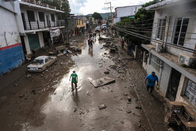 <p>Street covered in mud and debris caused by heavy rains in the Las Granjas neighborhood in Poza Rica, Veracruz state, on 14 October</p>