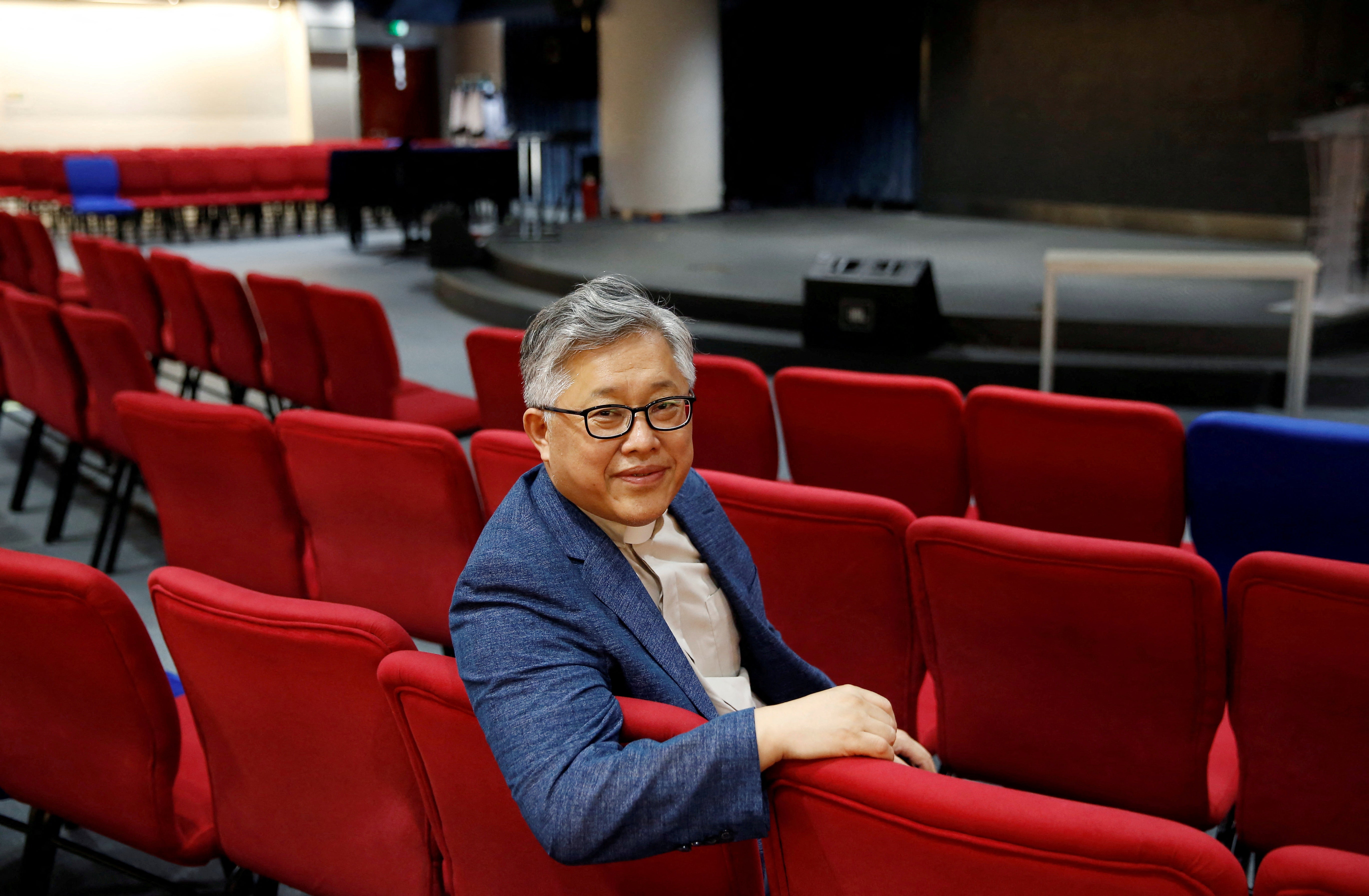 <p>File The head pastor of the Zion church in Beijing Jin Mingri poses for picures in the congregation hall of the unofficial Protestant "house" church in Beijing, China, August 28, 2018</p>