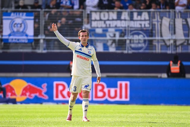 <p>Ex-Chelsea defender Ben Chilwell in action for Strasbourg, with a banner reading ‘Non a la multipropriete’ (’No to multi-ownership’) unfurled behind him</p>