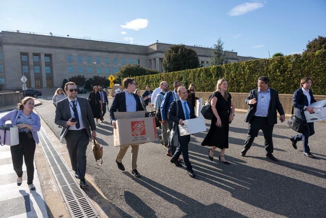 <p>Members of the Pentagon press corps carry their belongings out of the Pentagon after turning in their press credentials, Wednesday, Oct. 15, 2025 in Washington. (AP Photo/Kevin Wolf)</p>