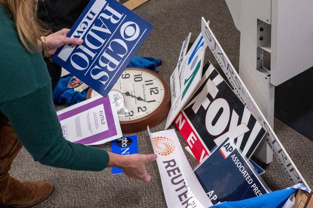 <p>Washington Post reporter Tara Copp saves the name plaques from various news organizations as she and members of the media pack up their belongings in the press area in the Pentagon, Wednesday, Oct. 15, 2025</p>