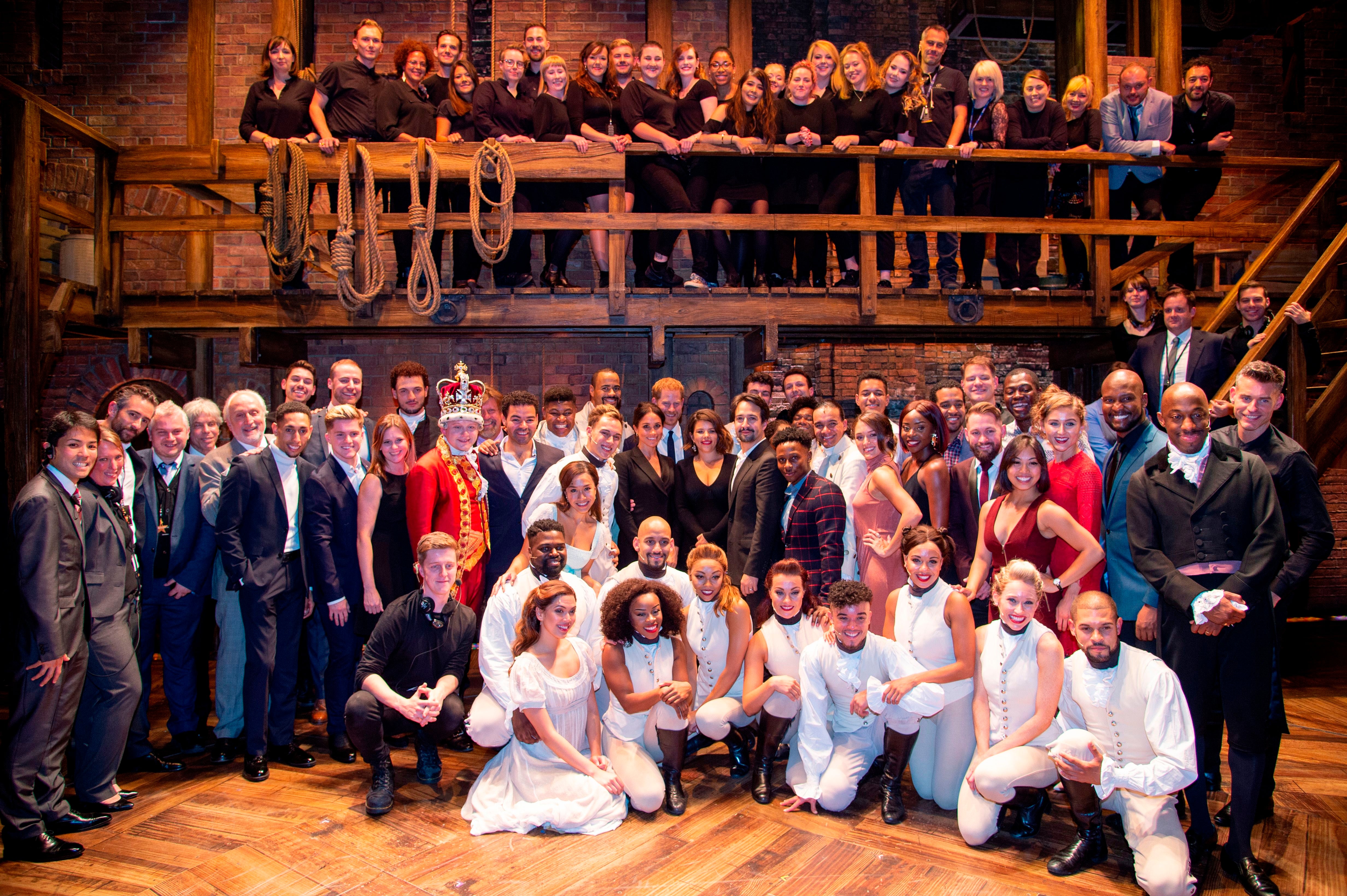 Mark says in her lawsuit that other members of the 'Hamilton' crew - seen here in a cast photo with Prince Harry and Meghan Markle - were allowed to work split-track shifts but she was fired.