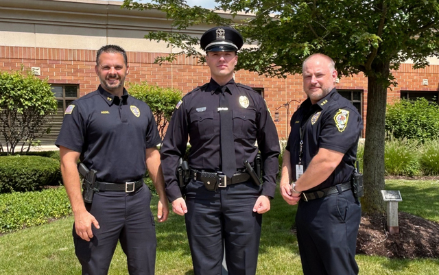 <p>Hanover Park Police Officer Radule Bojovic (center) was arrested by ICE agents</p>