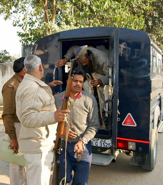 <p>Surinder Koli, accused in a case involving the gruesome deaths in Nithari, is escorted to court in Ghaziabad on the outskirts of New Delhi on 12 February 2009</p>