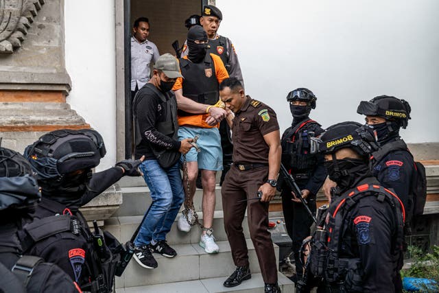<p>Australian suspect Darcy Francesco Jenson (C), 27, one of three men accused of murder over the shooting of Australian citizens, is escorted back to a prison after being questioned by prosecutors in Badung, Bali, on October 15, 2025</p>
