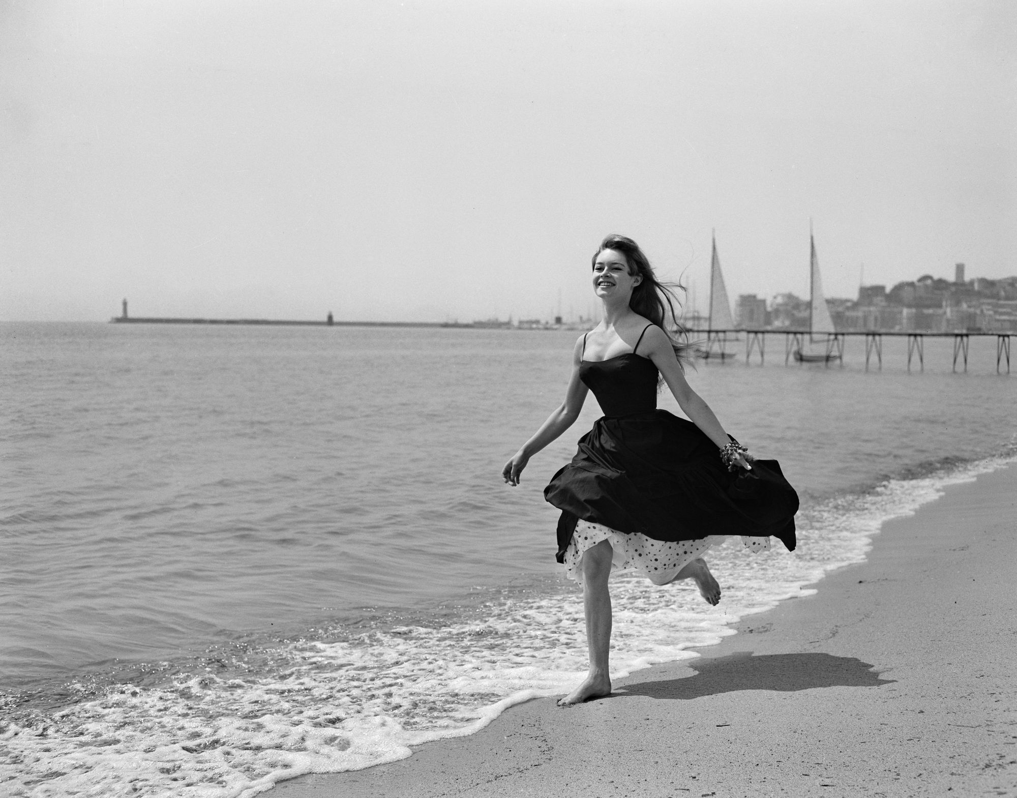 Bardot running barefoot on the sands at Cannes in 1956, the year of her breakout performance in ‘And God Created Woman’