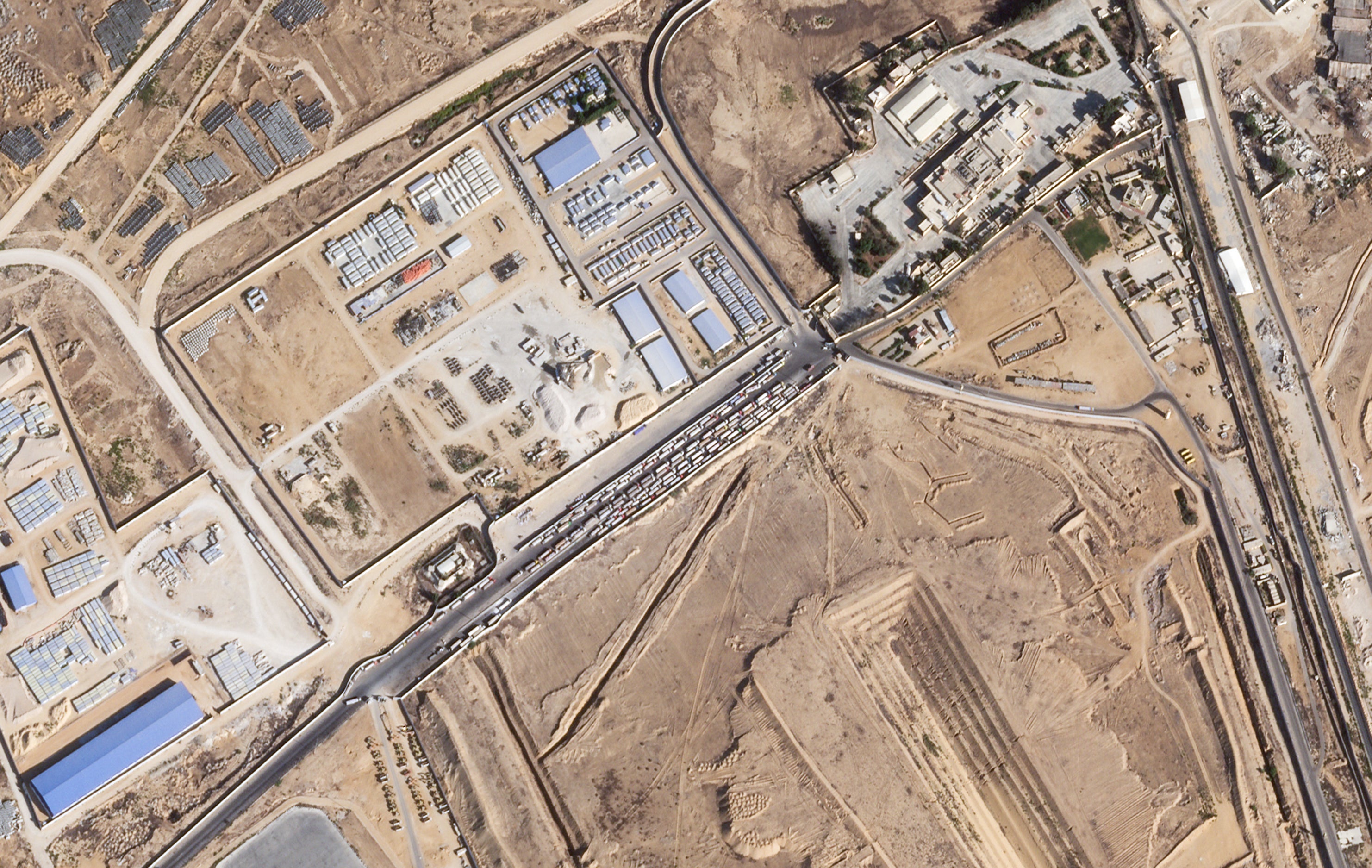 Trucks lined up on the Egyptian side of the Rafah border crossing with the Gaza Strip on Thursday, Oct. 16, 2025