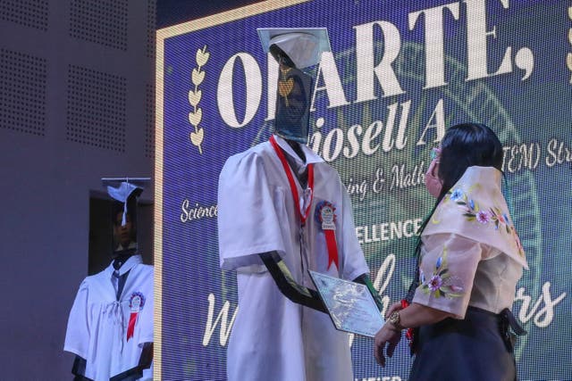<p>A robot stands in for an outgoing high school student at a 'cyber graduation' ceremony during the pandemic in Manila in the Philippines</p>