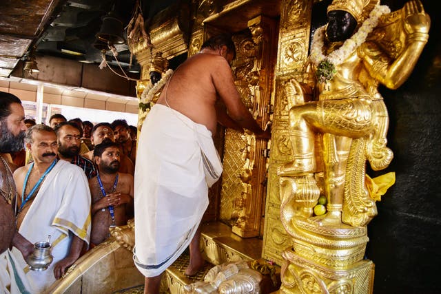 <p>File. An Indian priest closes doors to the Ayyappa shrine at the Sabarimala temple in Kerala after performing 'purification' rituals following the entry of two women on 2 January 2019</p>